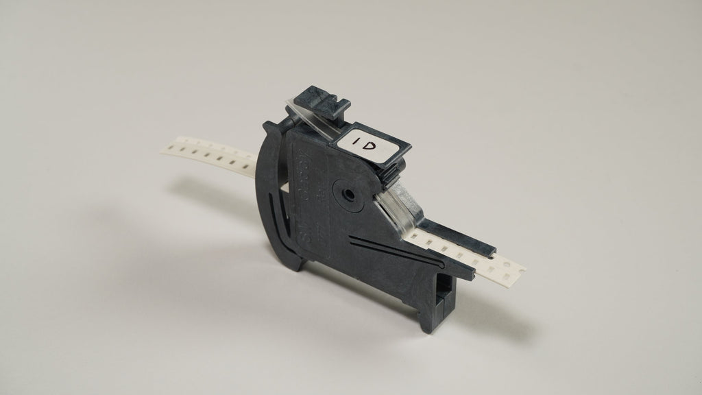 SMT Caddy MTI manual tape indexer loaded with 8 mm paper tape, label on the plunger
